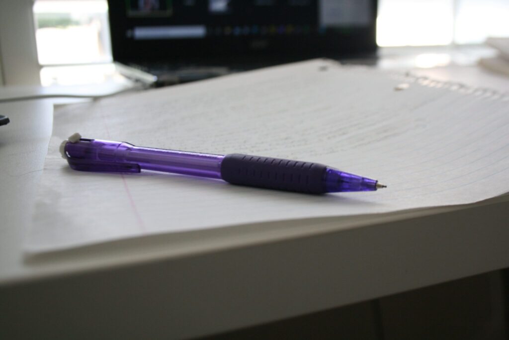 Purple pen on white desk